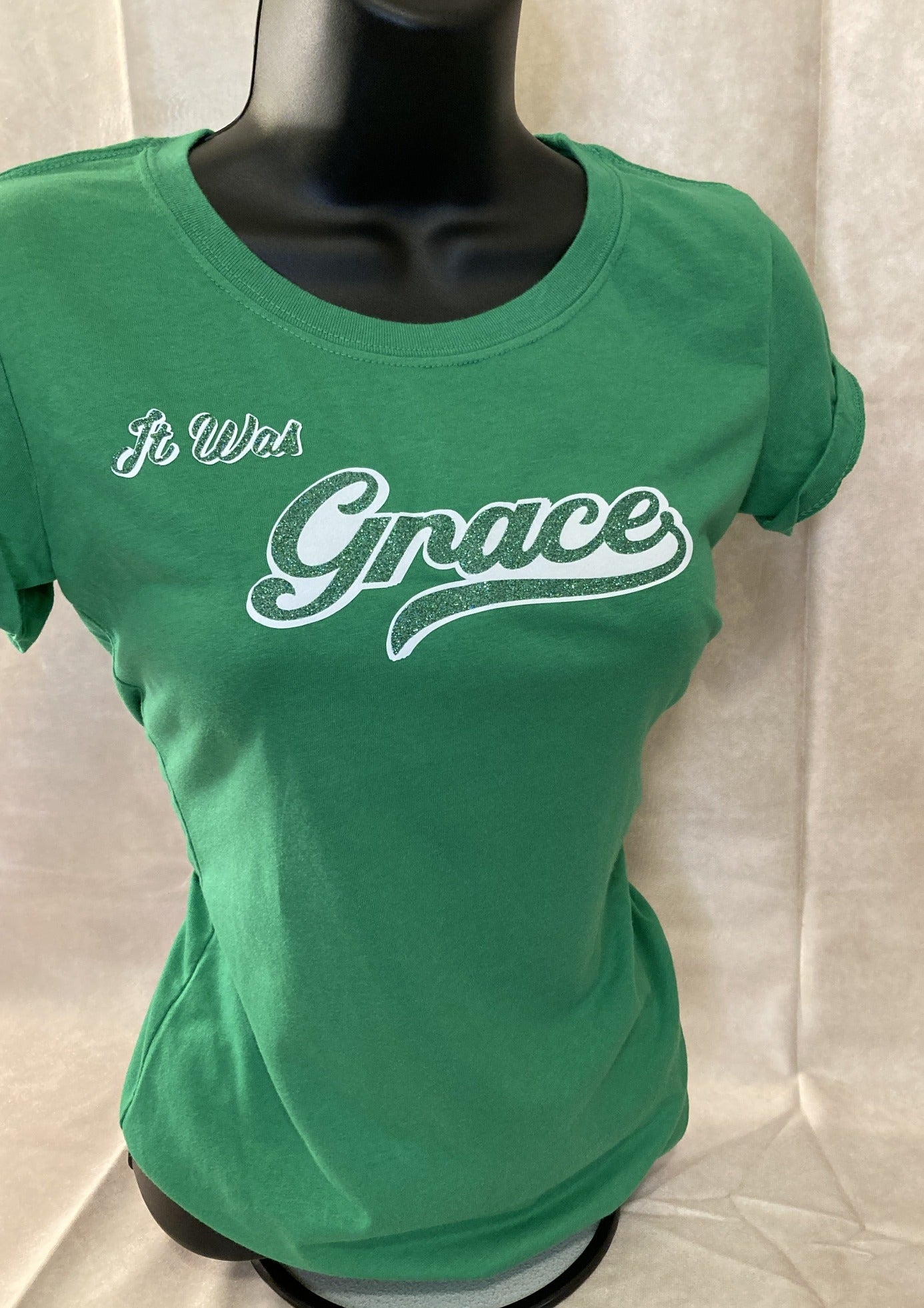 `Women’s Green “It Was Grace” Tee, Short Sleeve, Slight form fit, Soft feel, Machine Washable. 60% Cotton, 40% Polyester