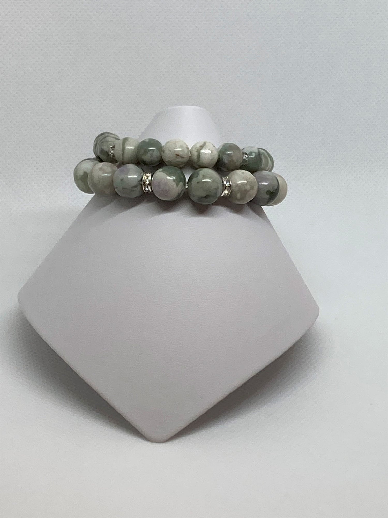 eace stones are a mixture of serpentine and white quartz. Natural blend of green and white. Rondelle and glass crystals accents.